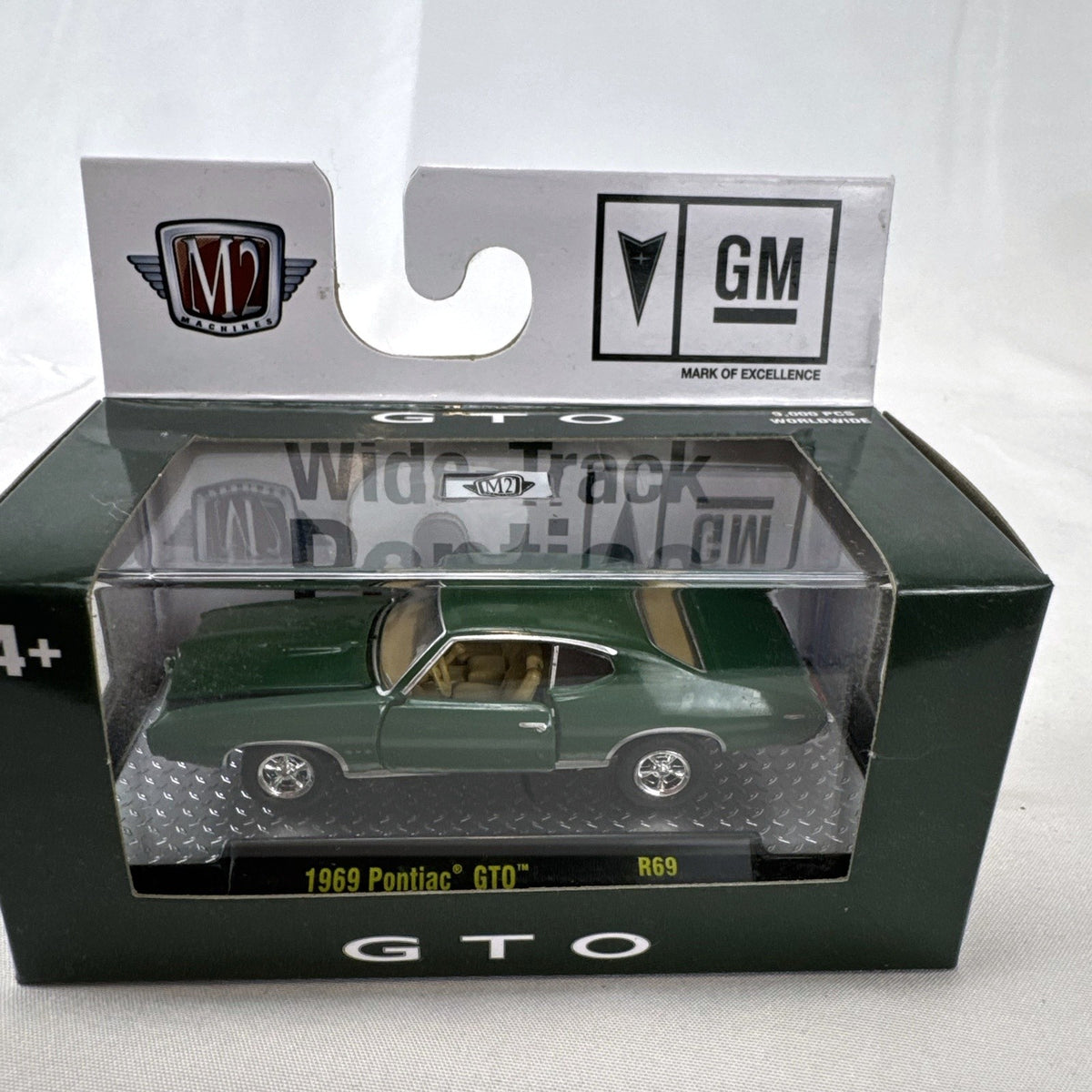 M2 Machines 1:64 scale 1969 Pontiac GTO diecast car in green, factory sealed in acrylic display case