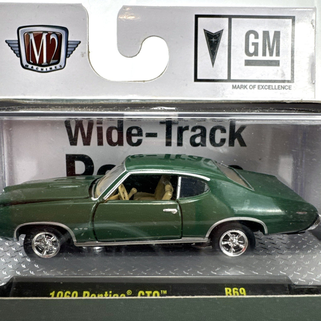 M2 Machines 1:64 scale 1969 Pontiac GTO diecast car in green, factory sealed in acrylic display case