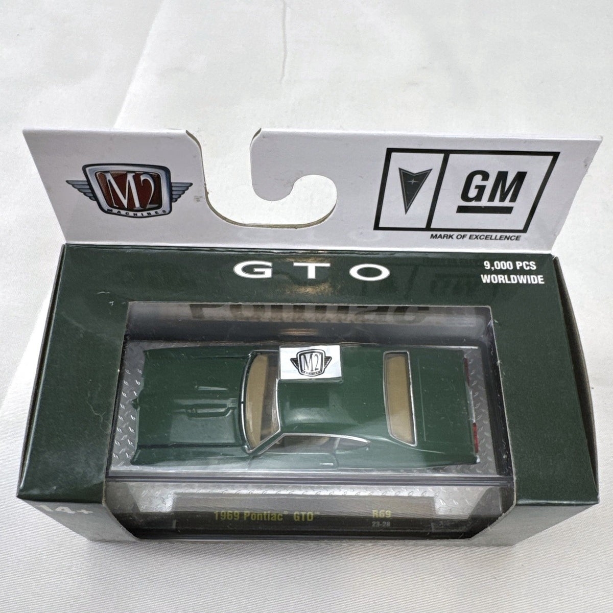 M2 Machines 1:64 scale 1969 Pontiac GTO diecast car in green, factory sealed in acrylic display case