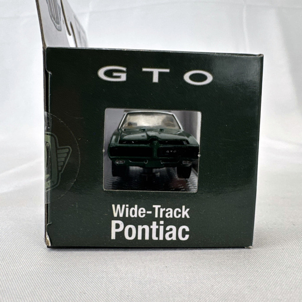 M2 Machines 1:64 scale 1969 Pontiac GTO diecast car in green, factory sealed in acrylic display case