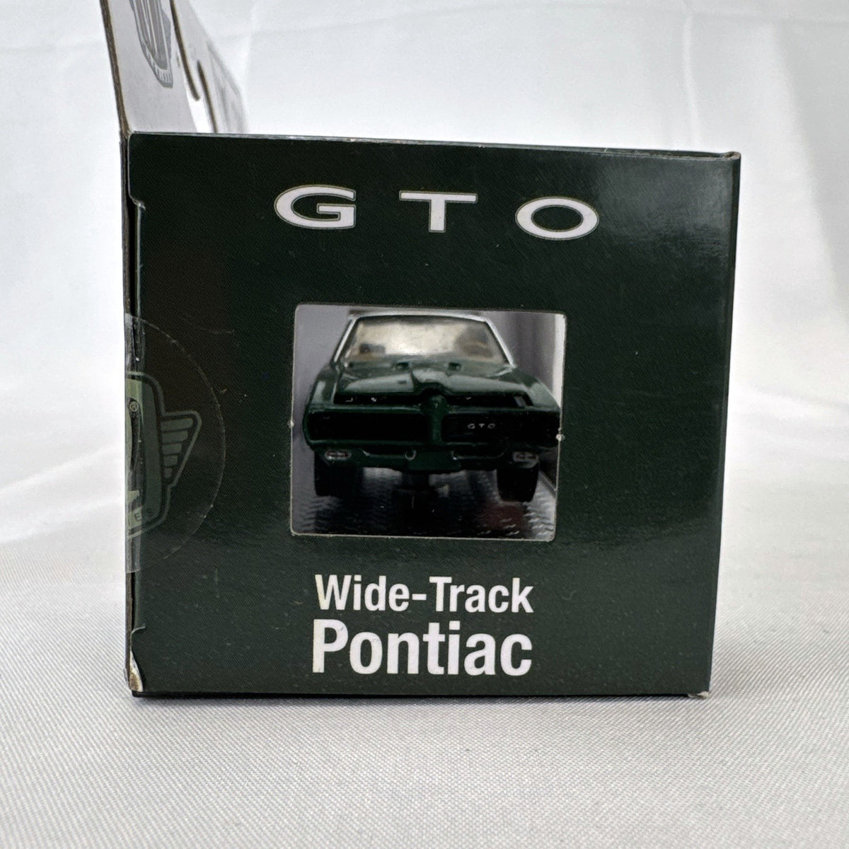 M2 Machines 1:64 scale 1969 Pontiac GTO diecast car in green, factory sealed in acrylic display case