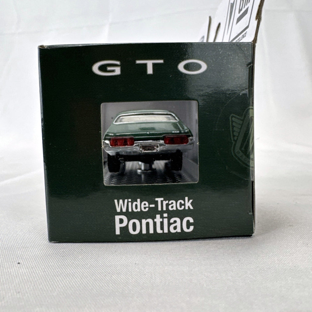 M2 Machines 1:64 scale 1969 Pontiac GTO diecast car in green, factory sealed in acrylic display case