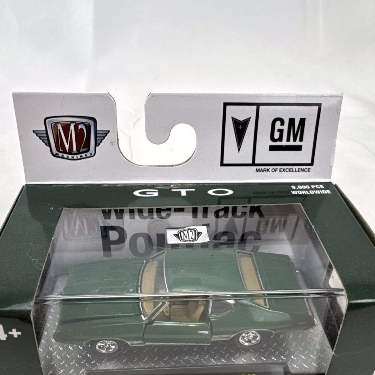 M2 Machines 1:64 scale 1969 Pontiac GTO diecast car in green, factory sealed in acrylic display case