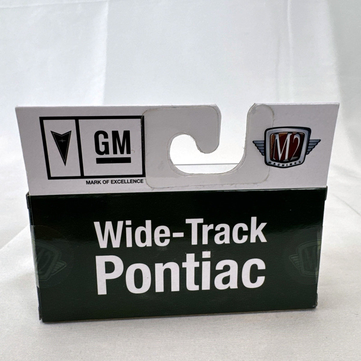 M2 Machines 1:64 scale 1969 Pontiac GTO diecast car in green, factory sealed in acrylic display case