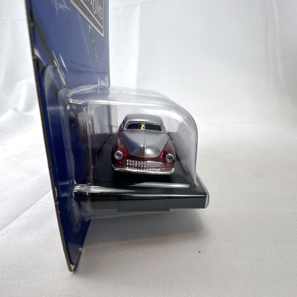 M2 Machines 1:64 scale 1949 Mercury Custom diecast car in metallic red and silver