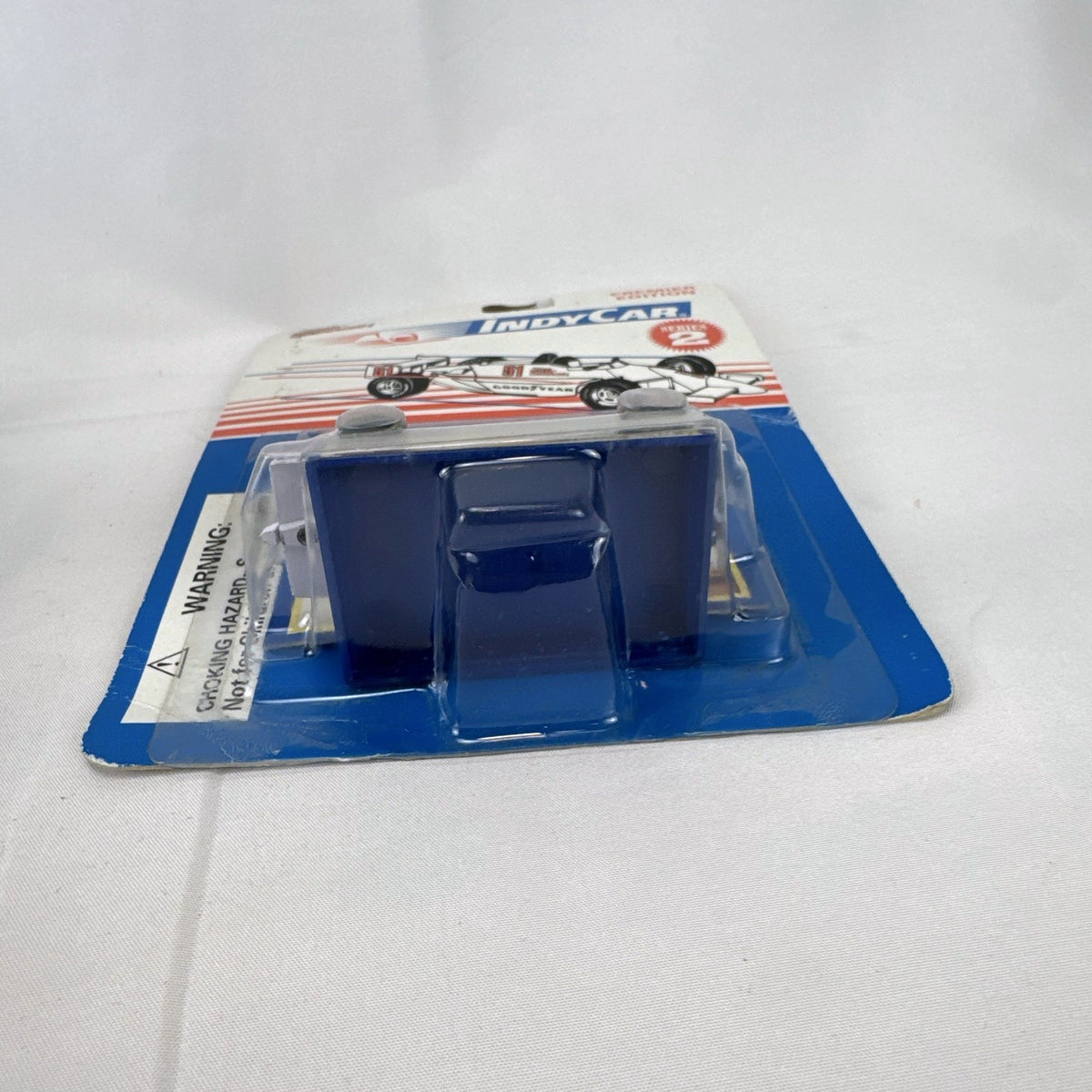 Racing Champions 1:64 diecast Robby Gordon #5 Valvoline IndyCar in factory-sealed blister pack with display stand