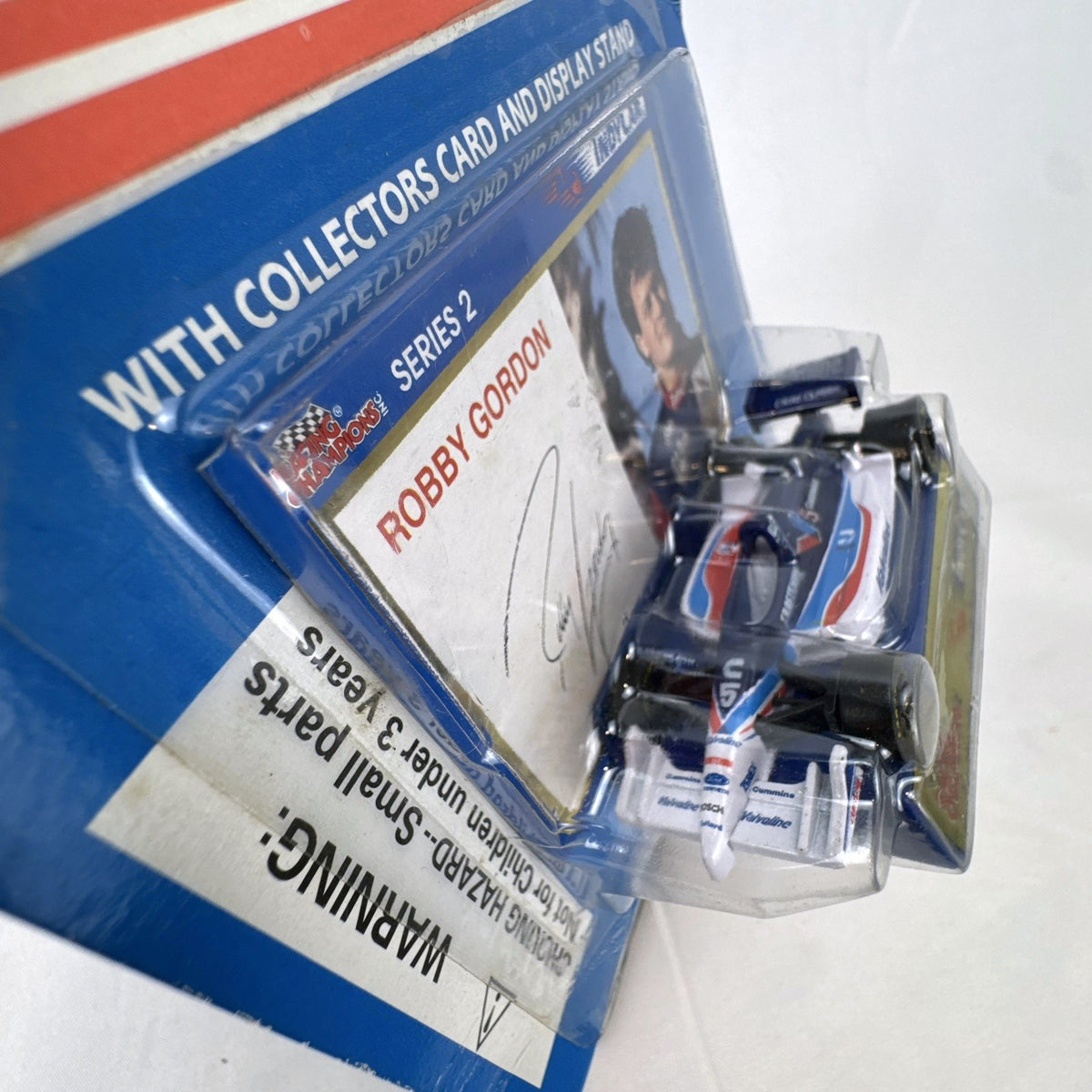 Racing Champions 1:64 diecast Robby Gordon #5 Valvoline IndyCar in factory-sealed blister pack with display stand