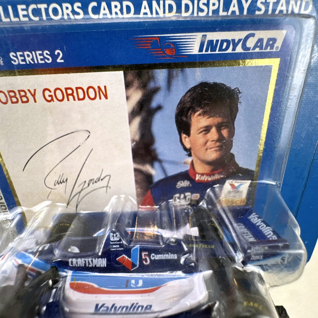 Racing Champions 1:64 diecast Robby Gordon #5 Valvoline IndyCar in factory-sealed blister pack with display stand