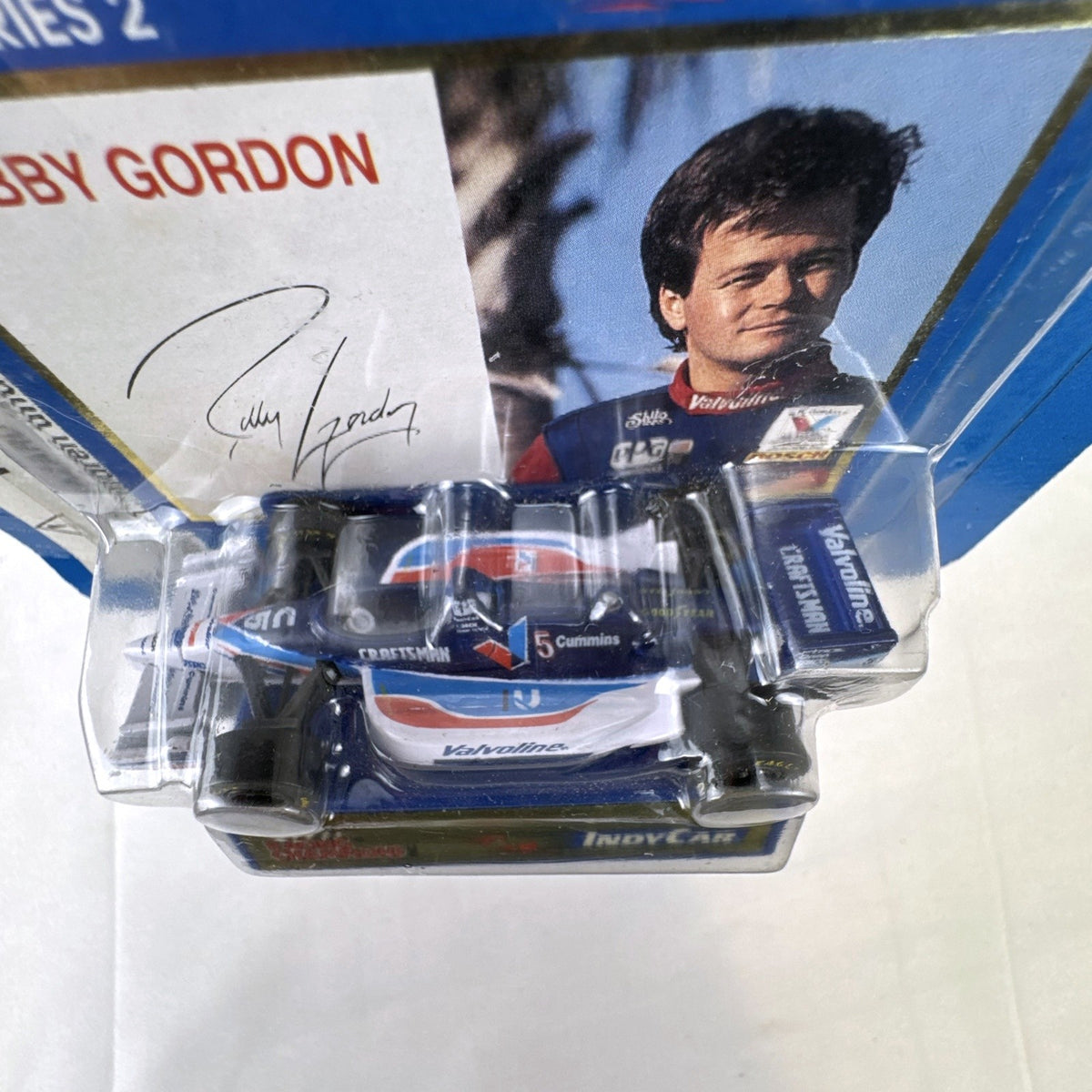 Racing Champions 1:64 diecast Robby Gordon #5 Valvoline IndyCar in factory-sealed blister pack with display stand
