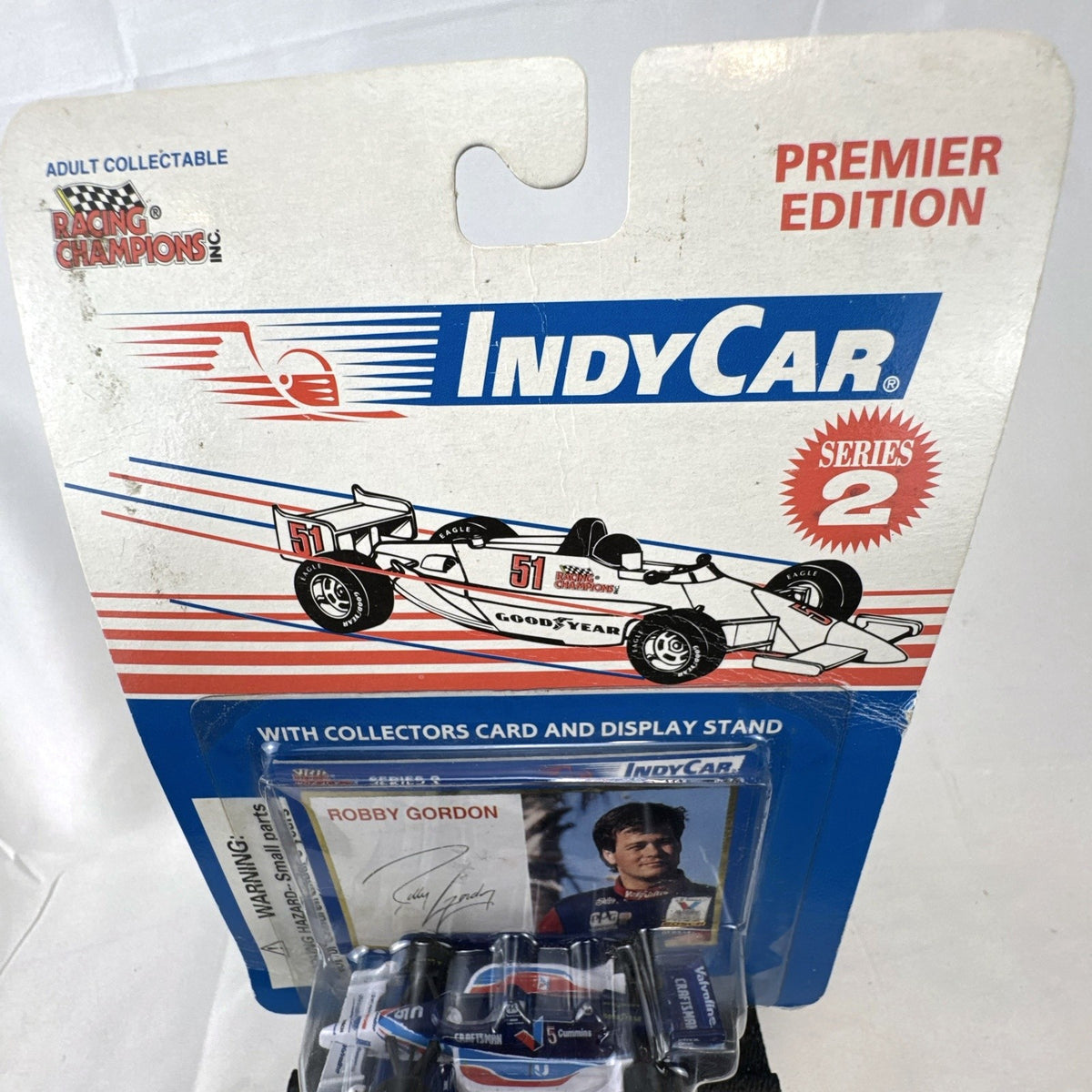 Racing Champions 1:64 diecast Robby Gordon #5 Valvoline IndyCar in factory-sealed blister pack with display stand