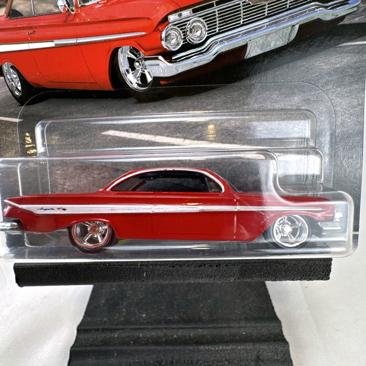 Hot Wheels Fast & Furious 1961 Chevrolet Impala 1:64 diecast car in gloss red with Real Riders tires in packaging.