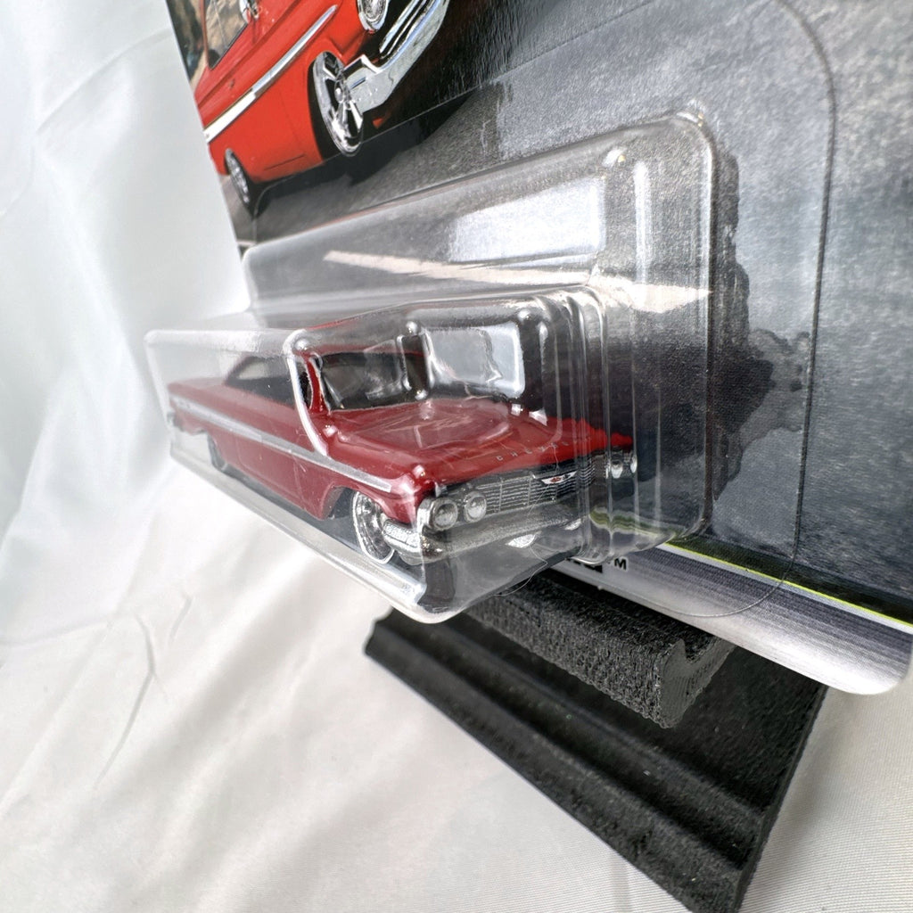 Hot Wheels Fast & Furious 1961 Chevrolet Impala 1:64 diecast car in gloss red with Real Riders tires in packaging.