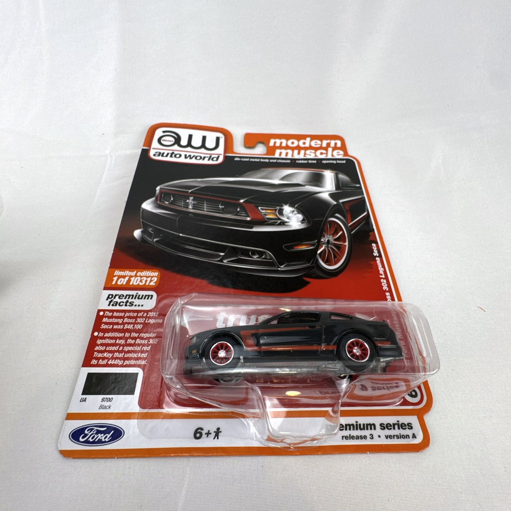 Auto World 1:64 scale 2012 Ford Mustang Boss 302 Laguna Seca diecast car in black with red accents in original packaging