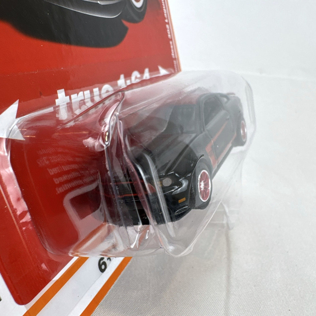 Auto World 1:64 scale 2012 Ford Mustang Boss 302 Laguna Seca diecast car in black with red accents in original packaging
