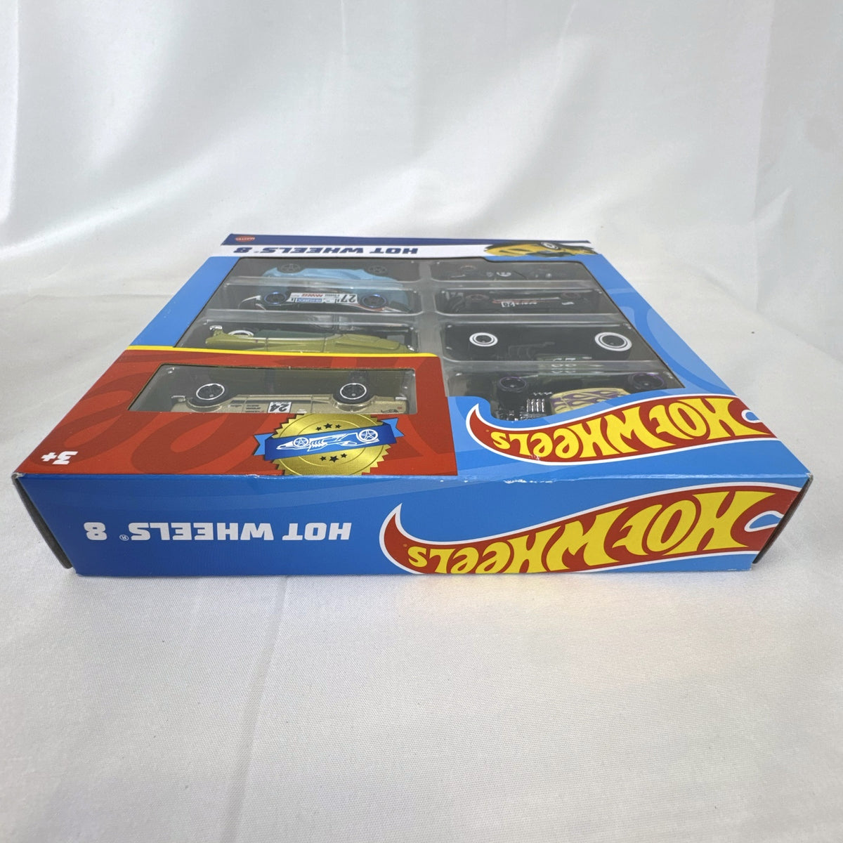 Hot Wheels 1:64 scale 8-car multipack in box featuring exclusive gold Nissan Skyline HT 2000GT-X