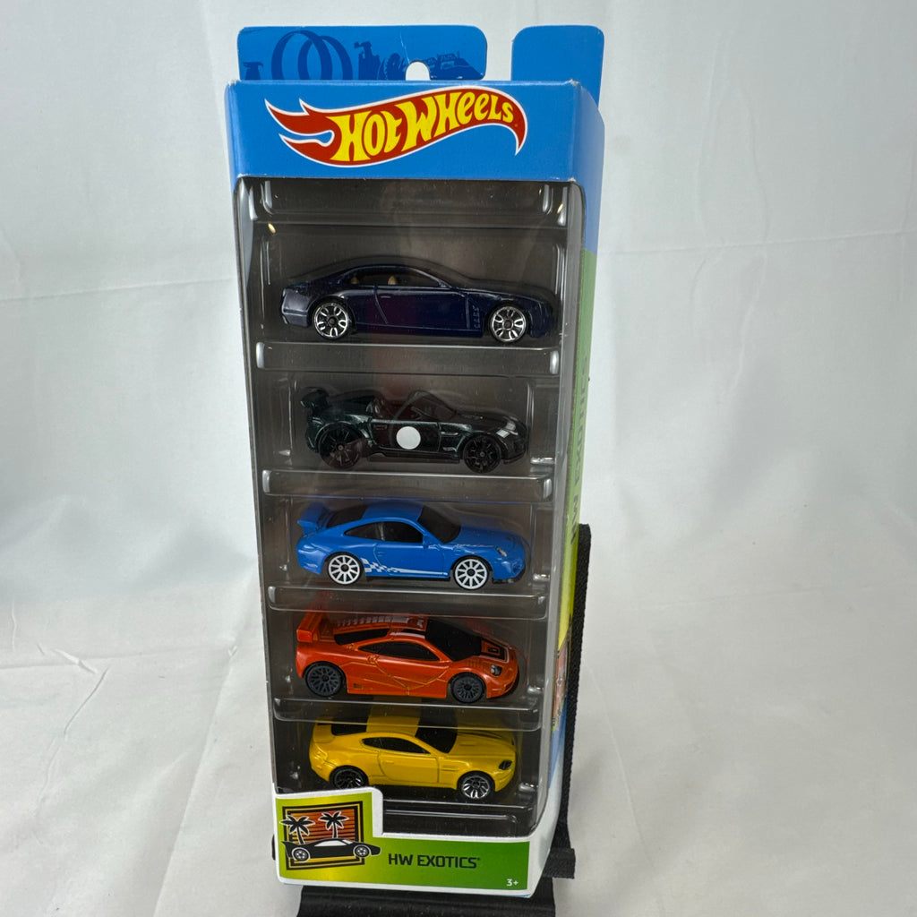Hot Wheels HW Exotics factory sealed 5-pack set containing McLaren, Porsche, Jaguar, Aston Martin, and Cadillac diecast cars.