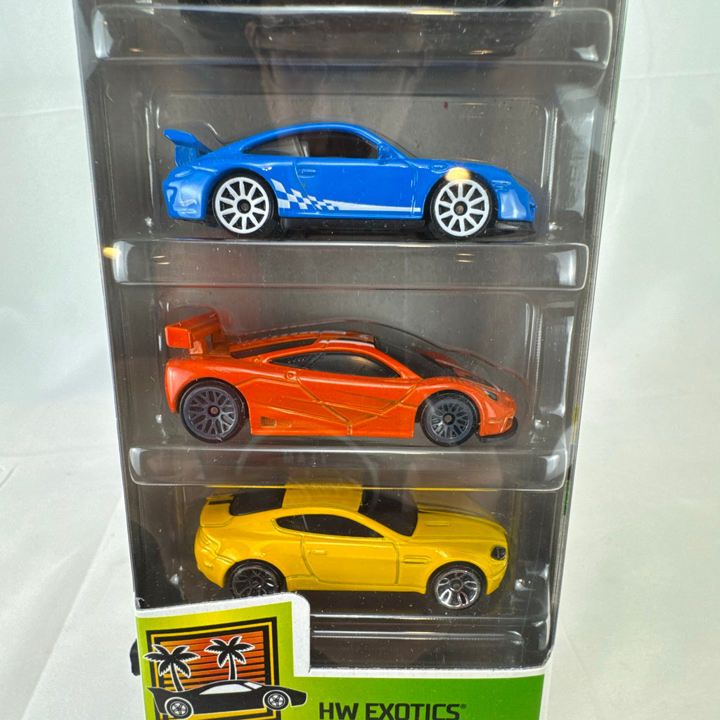 Hot Wheels HW Exotics factory sealed 5-pack set containing McLaren, Porsche, Jaguar, Aston Martin, and Cadillac diecast cars.