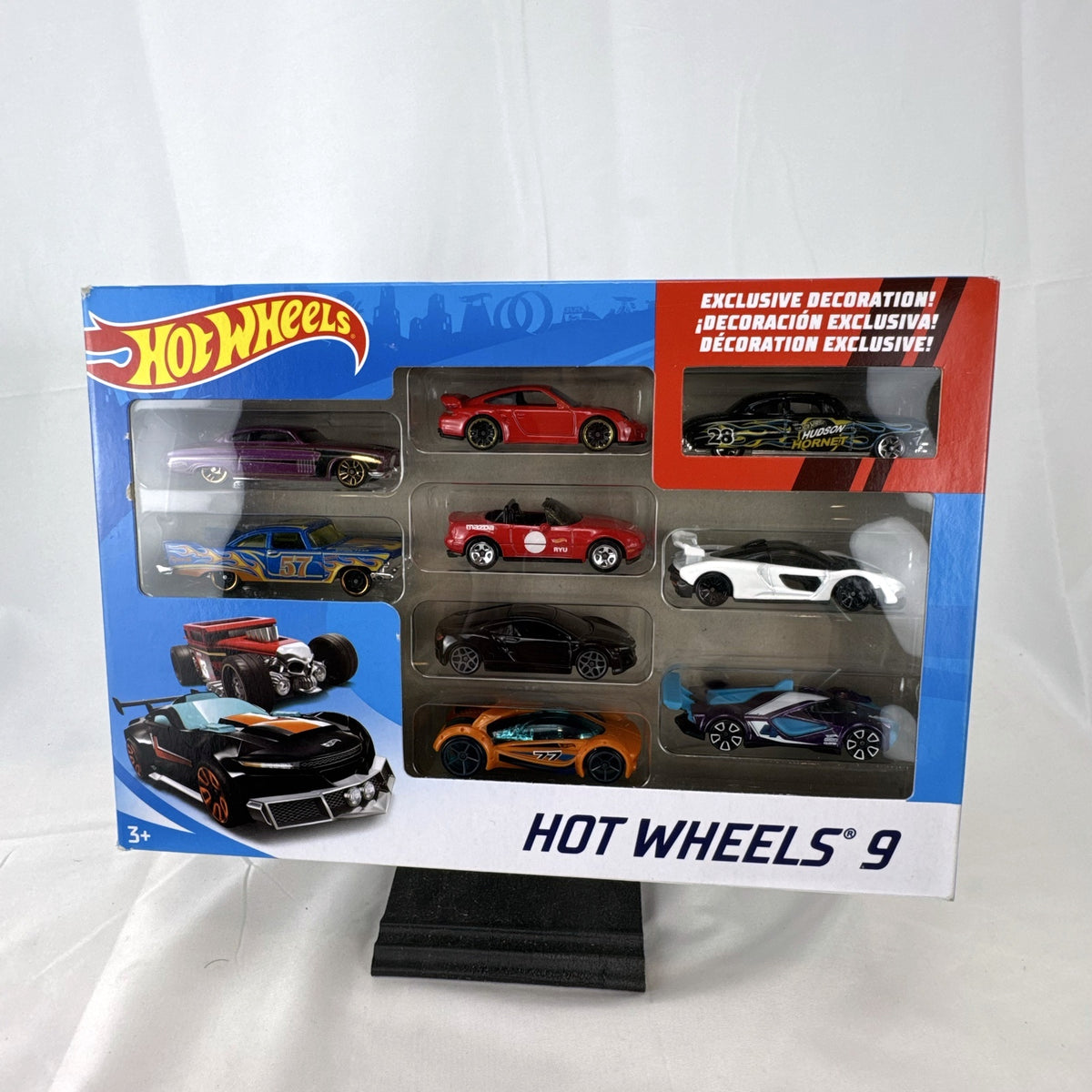 Hot Wheels 1:64 scale 9-car diecast lot including exclusive black '52 Hudson Hornet with flame graphics.