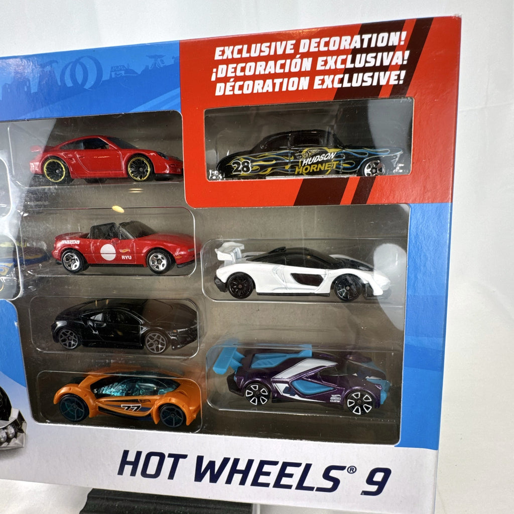 Hot Wheels 1:64 scale 9-car diecast lot including exclusive black '52 Hudson Hornet with flame graphics.