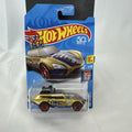 Hot Wheels Tour De Fast 1:64 scale diecast car in metallic gold on original blister card