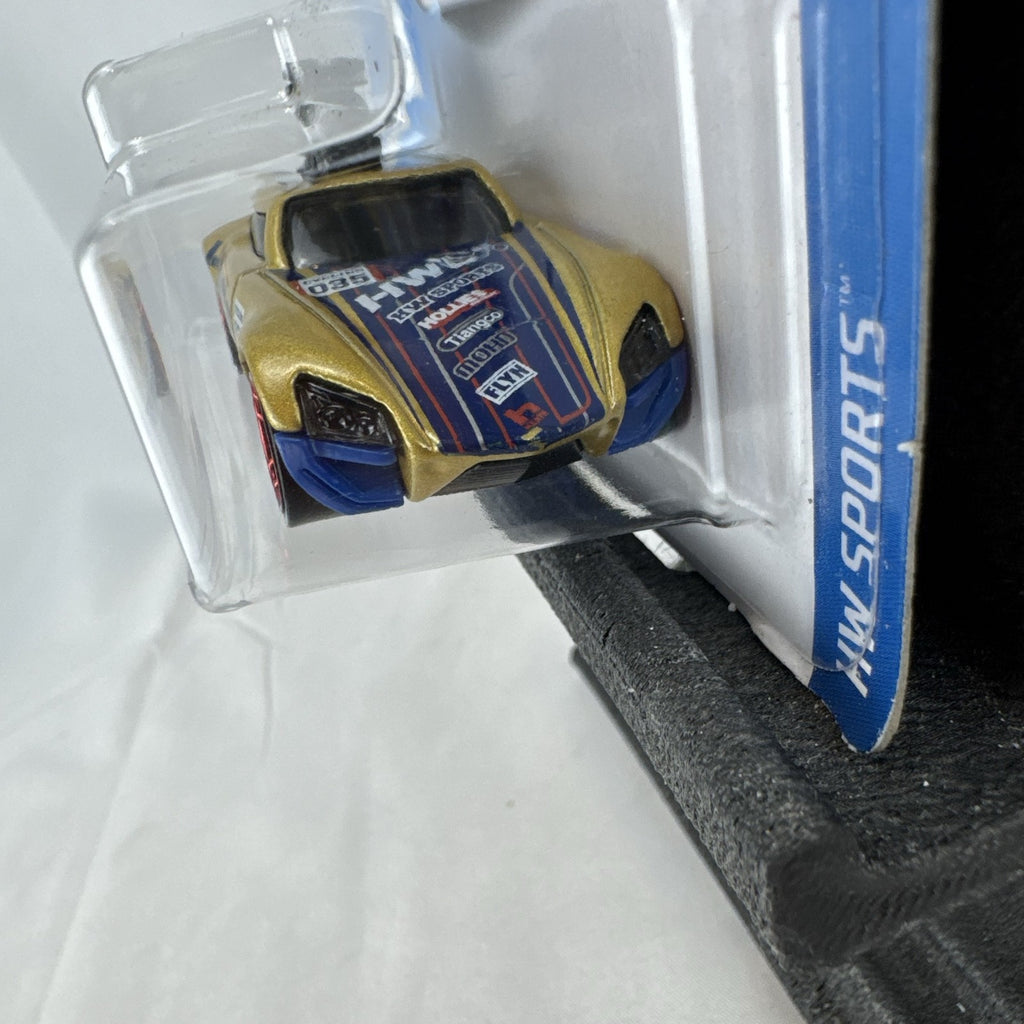 Hot Wheels Tour De Fast 1:64 scale diecast car in metallic gold on original blister card
