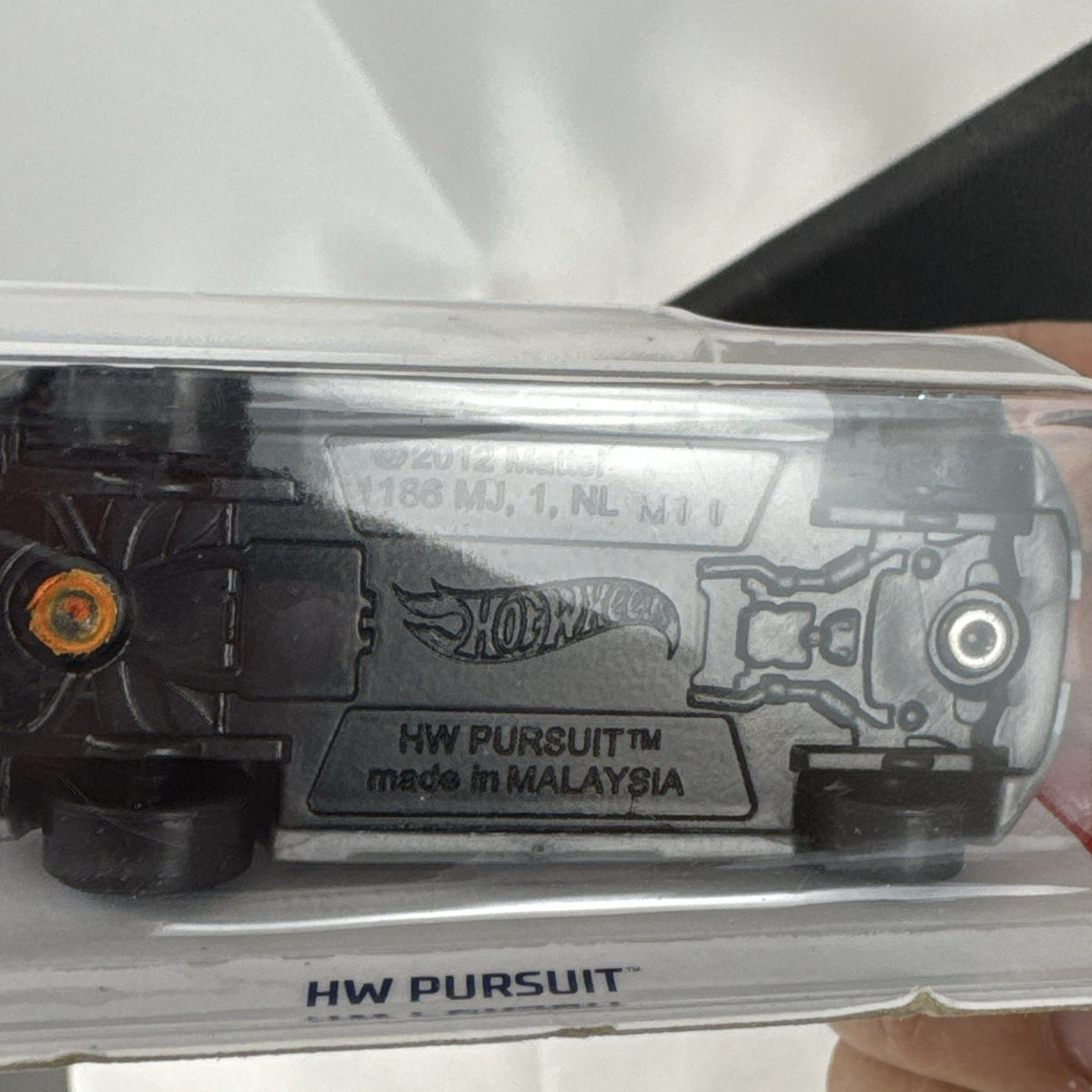 Orange Hot Wheels HW Pursuit 1:64 scale police interceptor diecast car sealed on original card package.