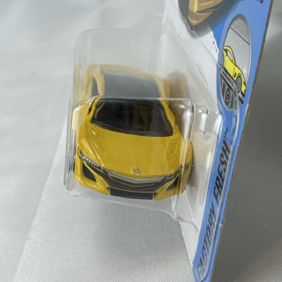 Hot Wheels 1:64 scale 2017 Acura NSX diecast car in bright yellow in original unopened blister pack