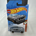 Hot Wheels 1:64 scale Custom Ford Maverick diecast car in metallic gray with GReddy livery on original card