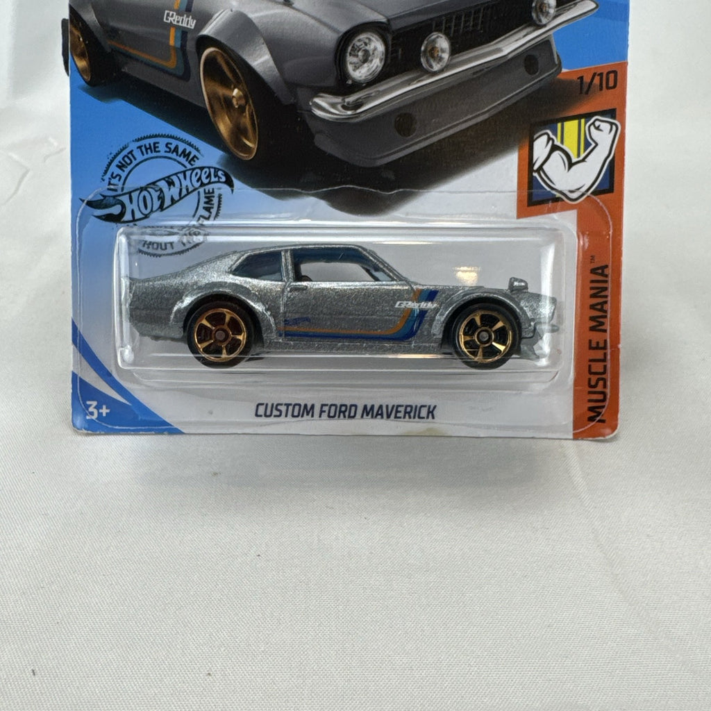 Hot Wheels 1:64 scale Custom Ford Maverick diecast car in metallic gray with GReddy livery on original card