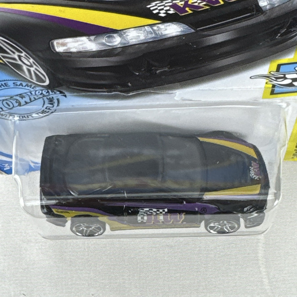 Hot Wheels 1:64 diecast Custom 01 Acura Integra GSR in black with yellow and purple KW suspension graphics on card.