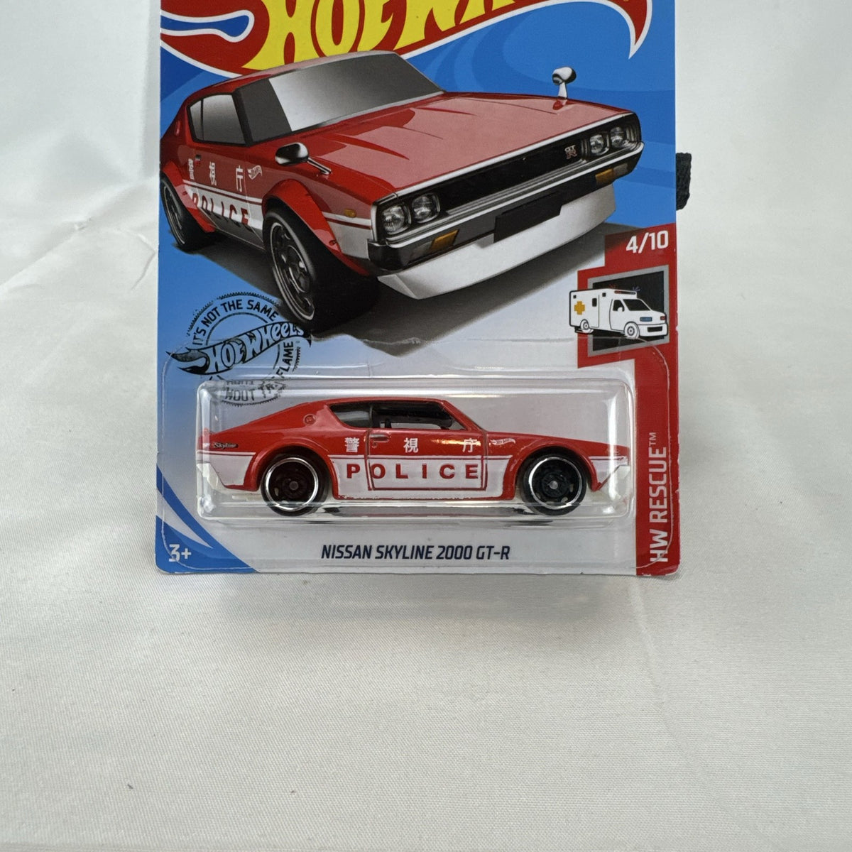 Sealed Hot Wheels 1:64 scale red Nissan Skyline 2000 GT-R HW Rescue Japanese police car diecast in blister pack.