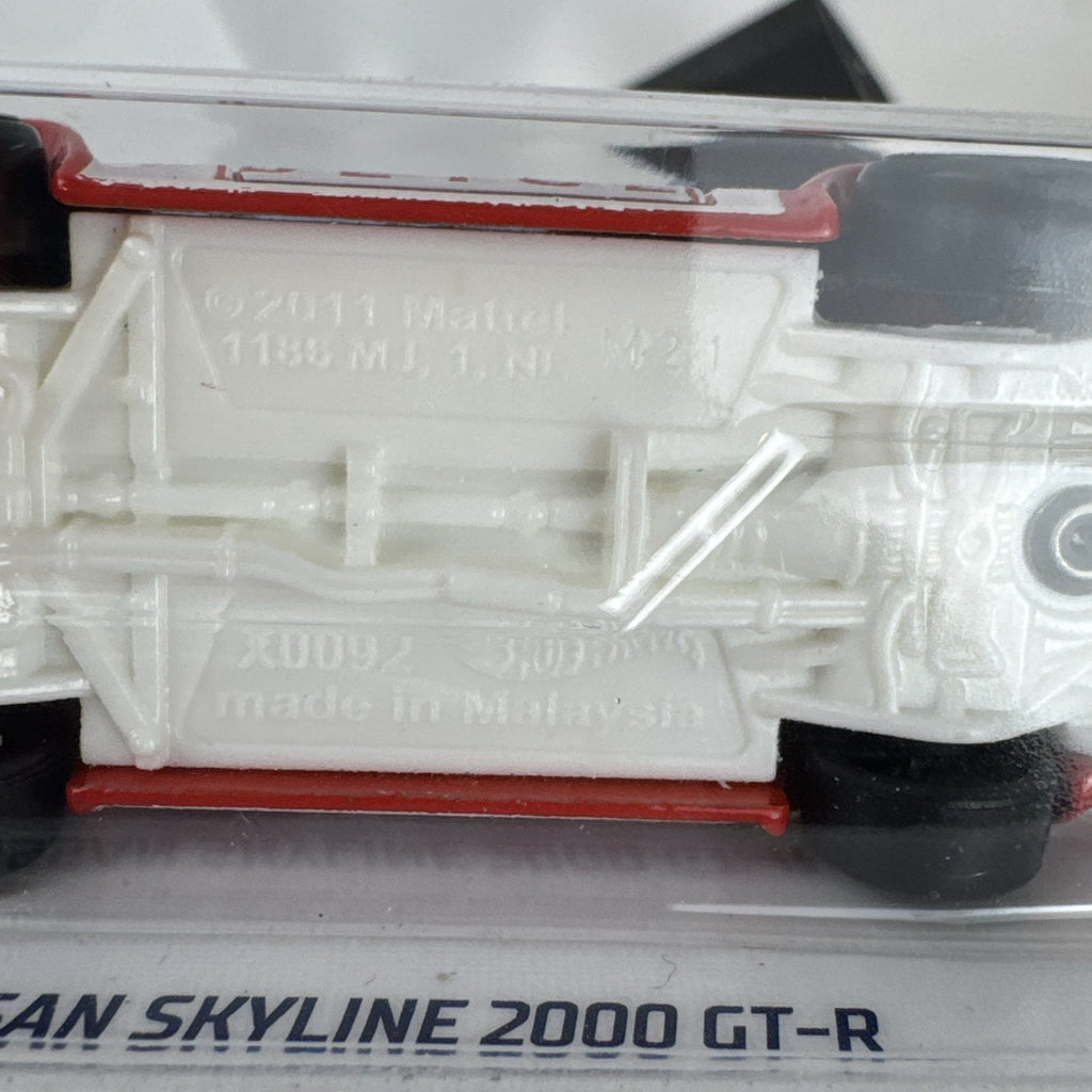 Sealed Hot Wheels 1:64 scale red Nissan Skyline 2000 GT-R HW Rescue Japanese police car diecast in blister pack.