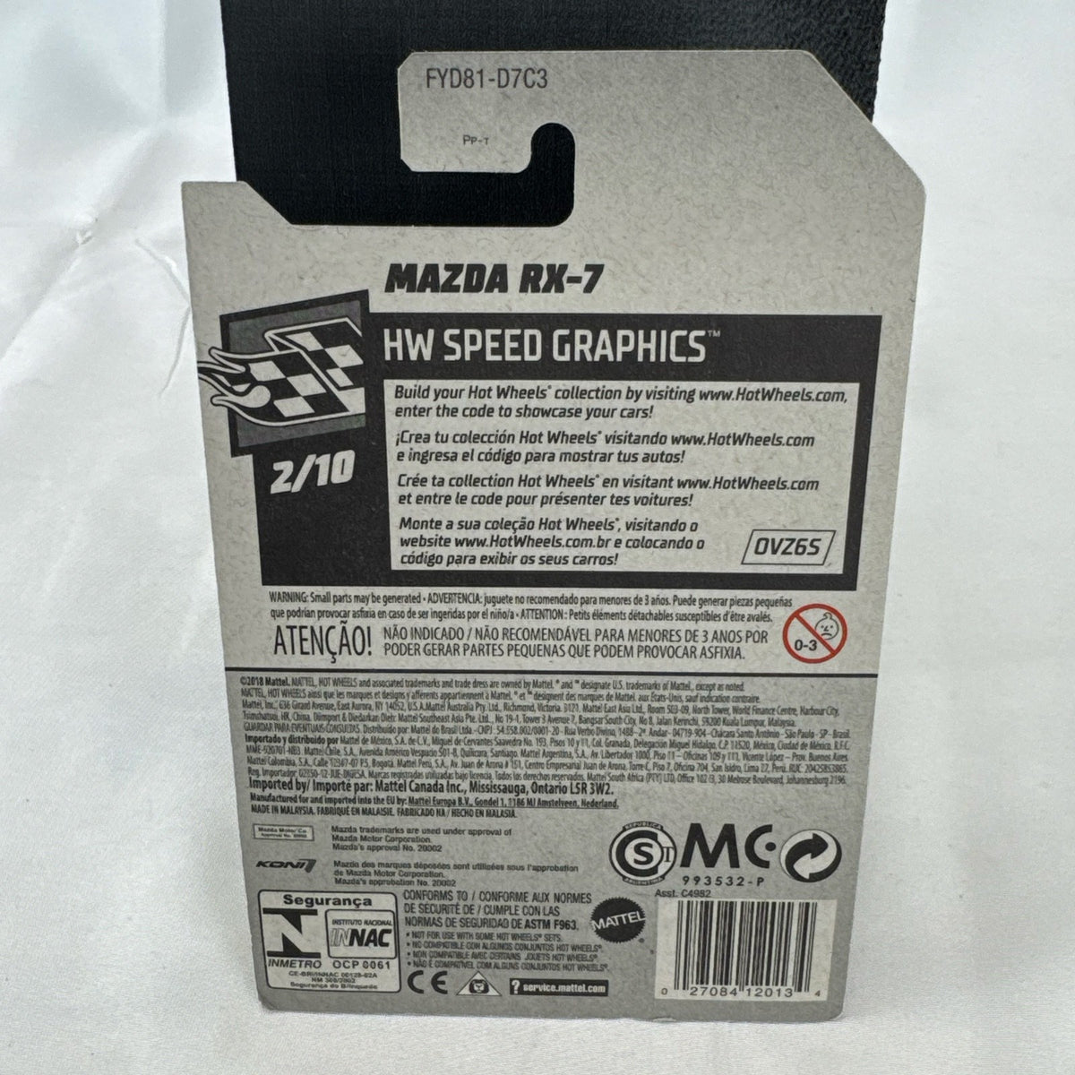 Hot Wheels 1:64 scale metallic green Mazda RX-7 diecast car with KONI graphics in factory sealed packaging.