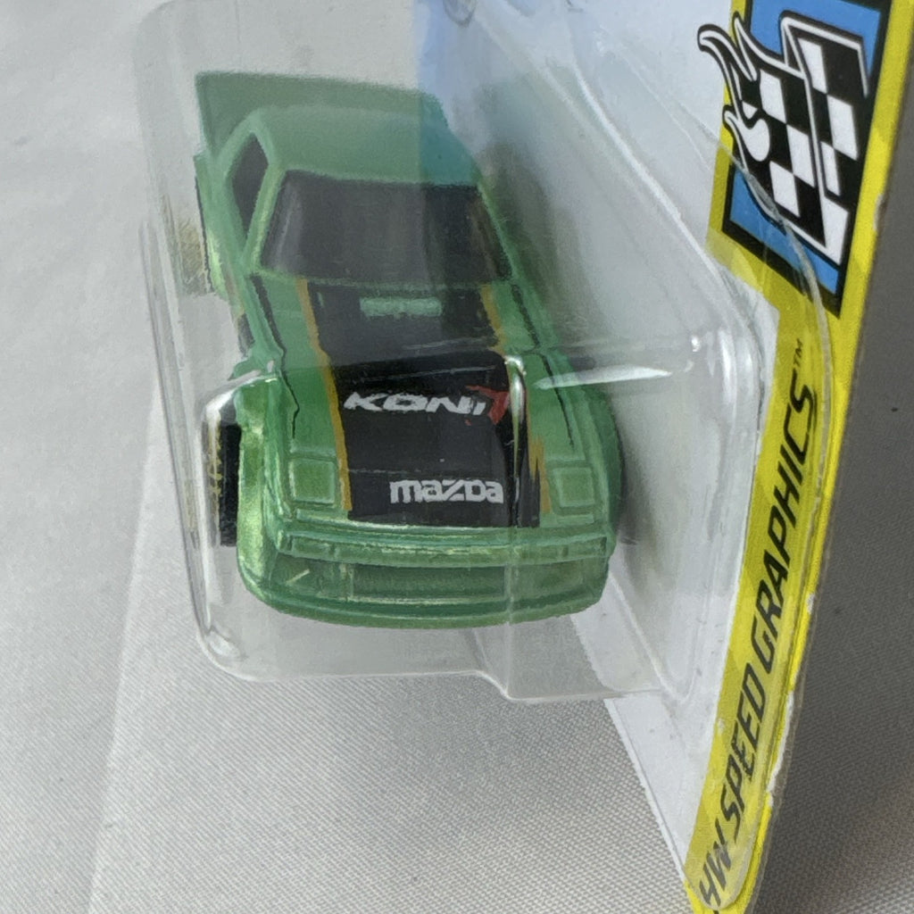 Hot Wheels 1:64 scale metallic green Mazda RX-7 diecast car in original packaging with Koni racing graphics.