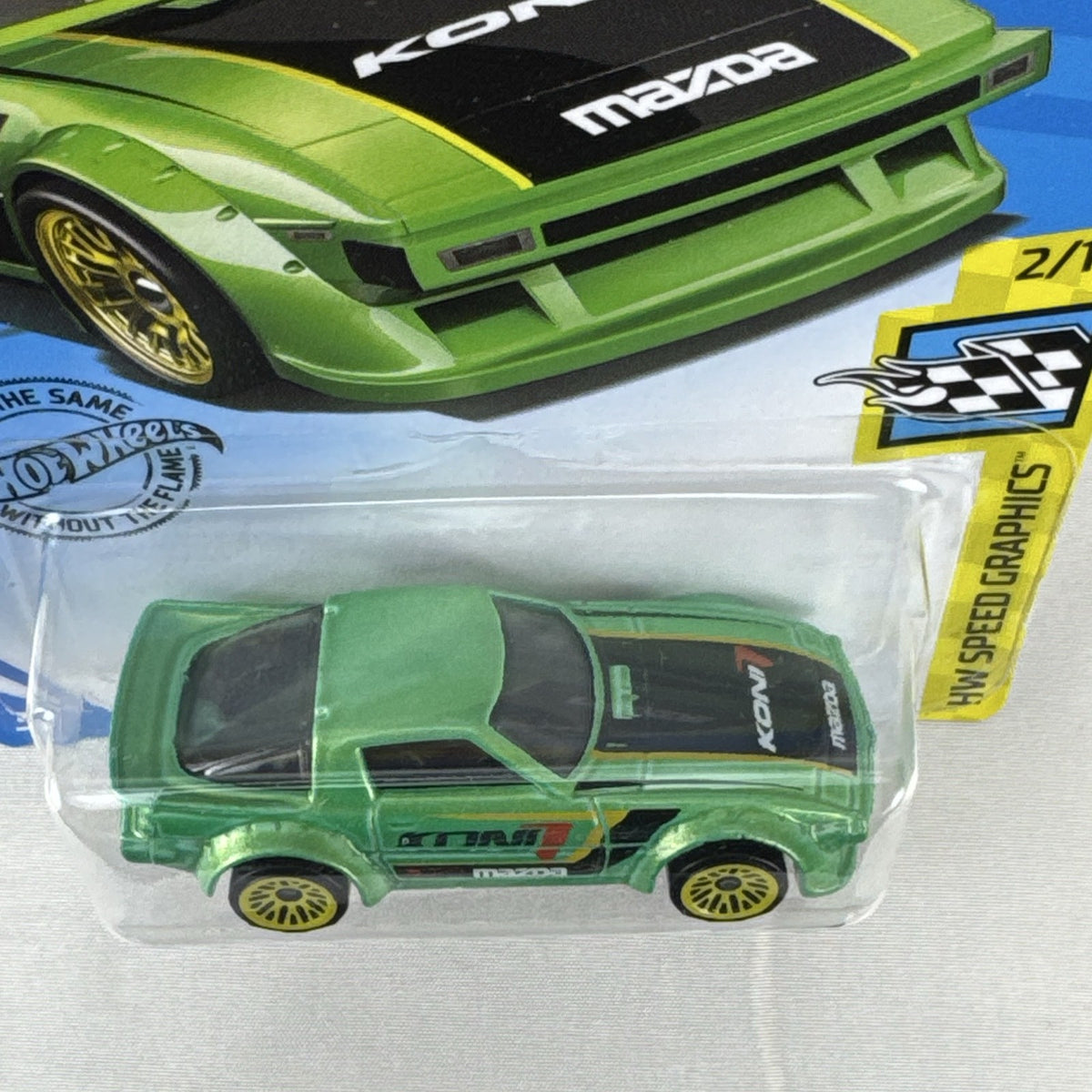Hot Wheels 1:64 scale metallic green Mazda RX-7 diecast car in original packaging with Koni racing graphics.