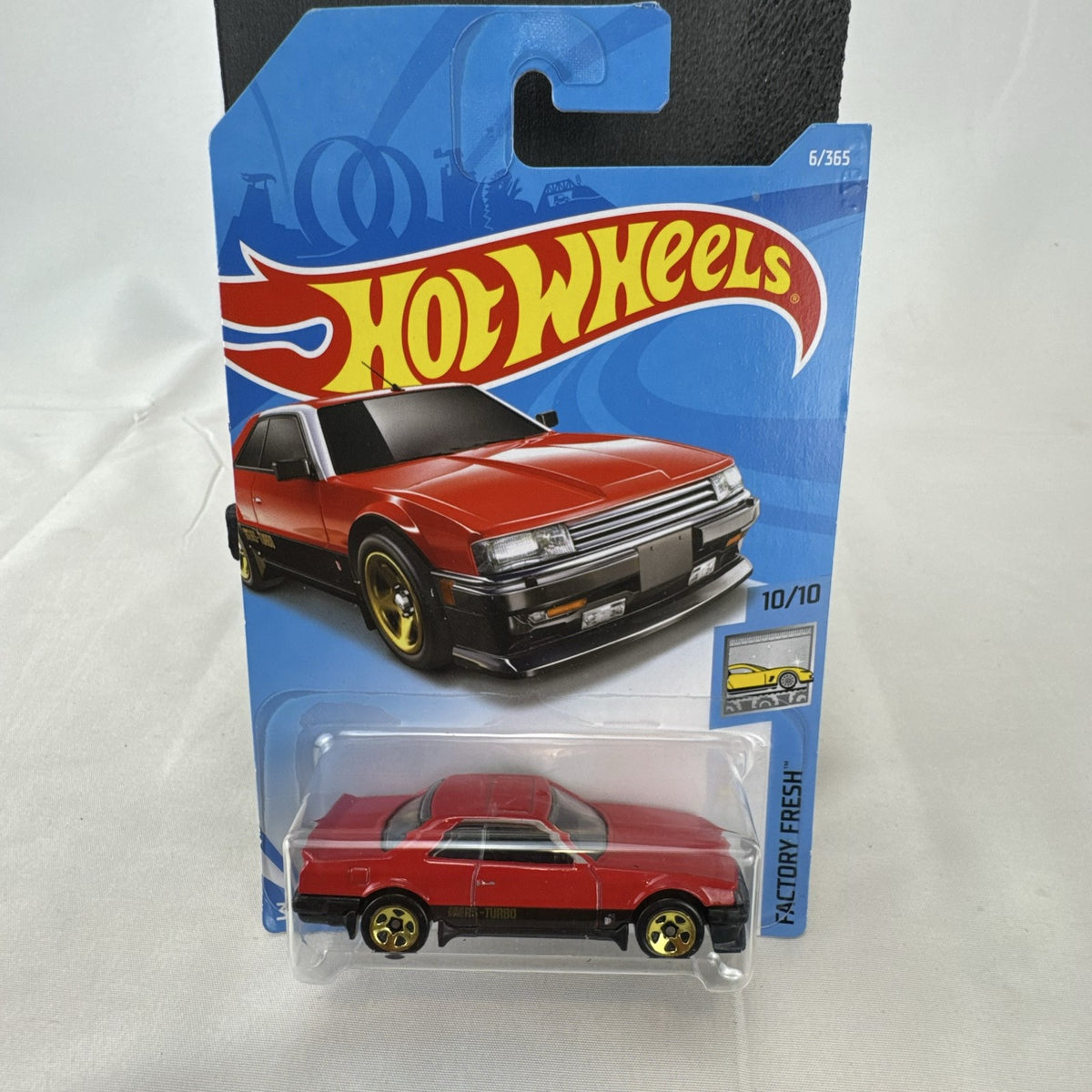Hot Wheels 1982 Nissan Skyline R30 1:64 scale diecast car in factory-sealed packaging with red and black two-tone finish