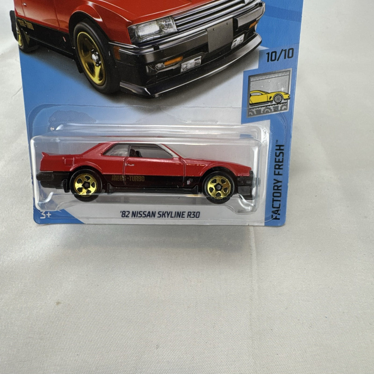 Hot Wheels 1982 Nissan Skyline R30 1:64 scale diecast car in factory-sealed packaging with red and black two-tone finish