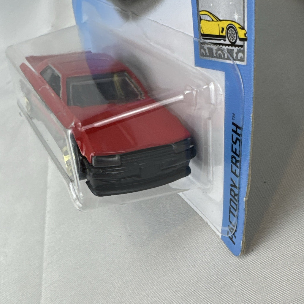 Hot Wheels 1982 Nissan Skyline R30 1:64 scale diecast car in factory-sealed packaging with red and black two-tone finish