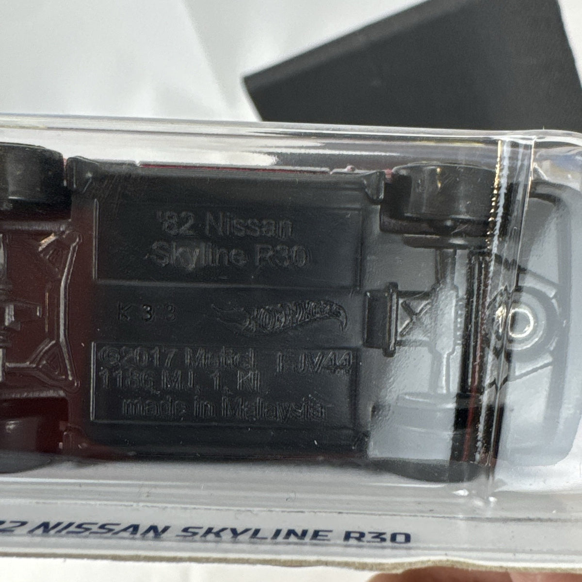 Hot Wheels 1982 Nissan Skyline R30 1:64 scale diecast car in factory-sealed packaging with red and black two-tone finish