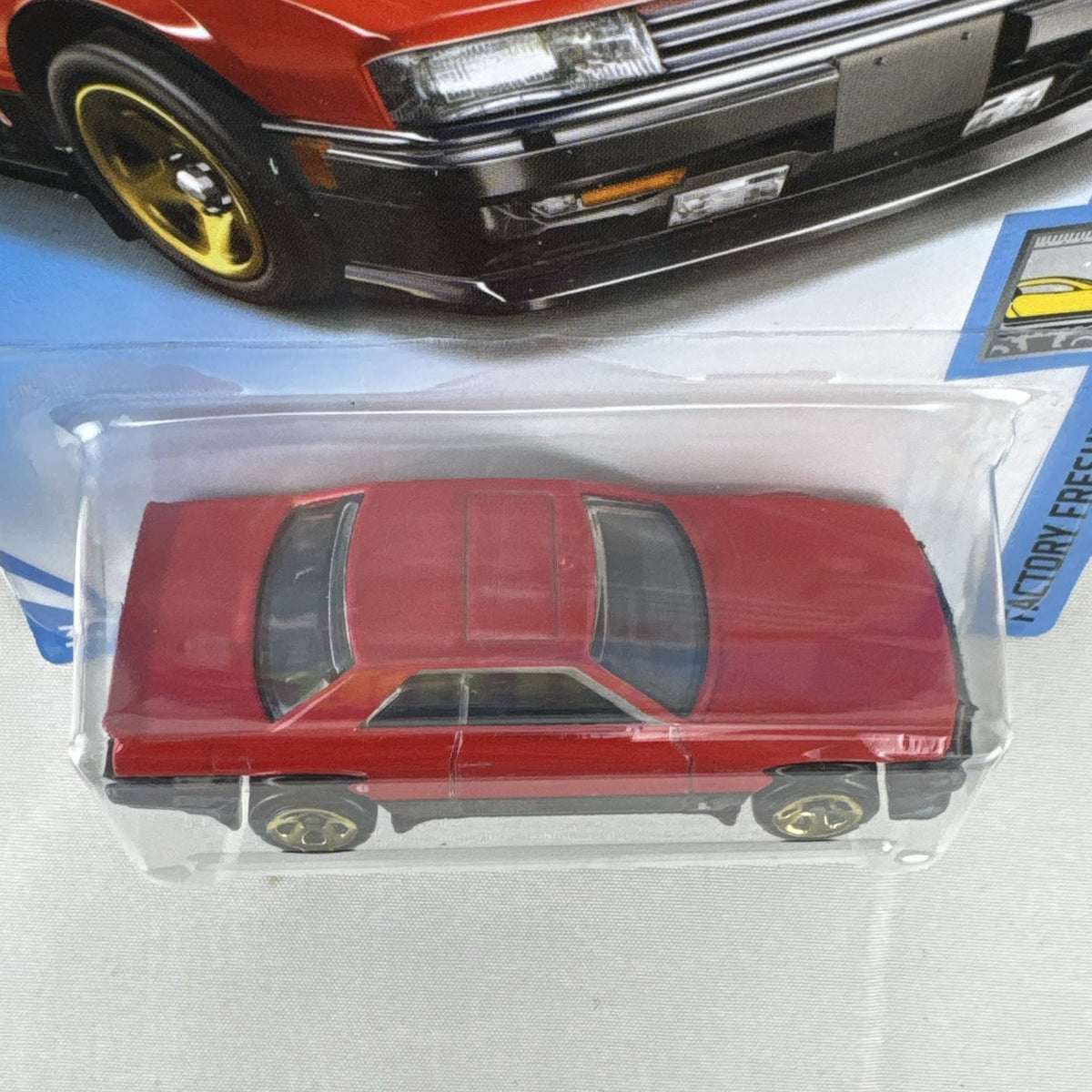 Hot Wheels 1982 Nissan Skyline R30 1:64 scale diecast car in factory-sealed packaging with red and black two-tone finish