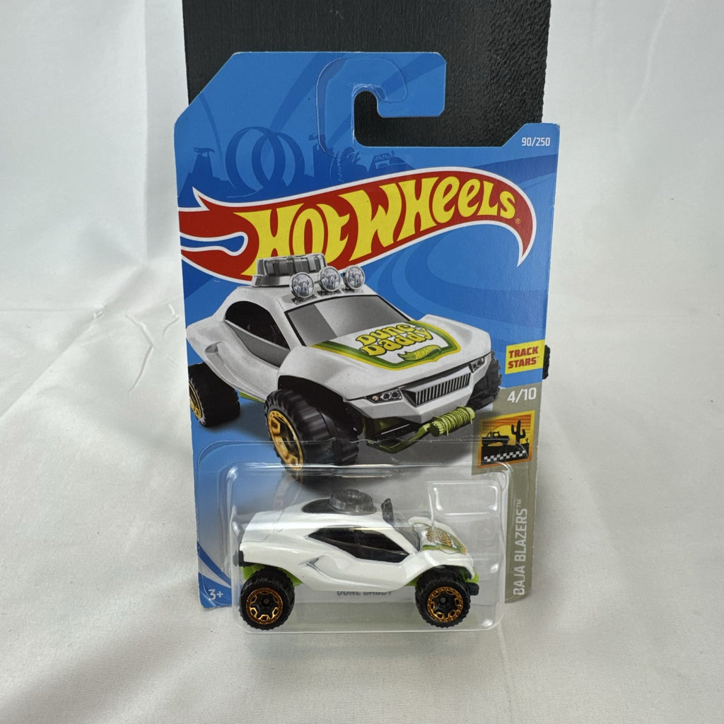 Sealed Hot Wheels 1:64 scale Dune Daddy diecast dune buggy in white with Baja Blazers graphics and gold-chrome rims.