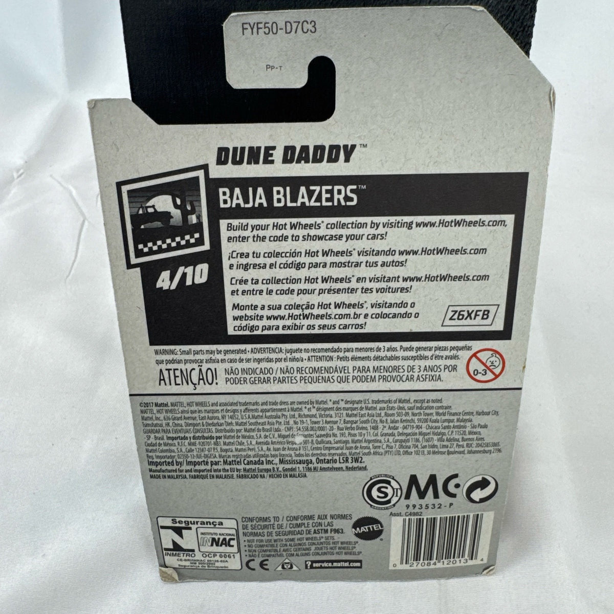 Sealed Hot Wheels 1:64 scale Dune Daddy diecast dune buggy in white with Baja Blazers graphics and gold-chrome rims.