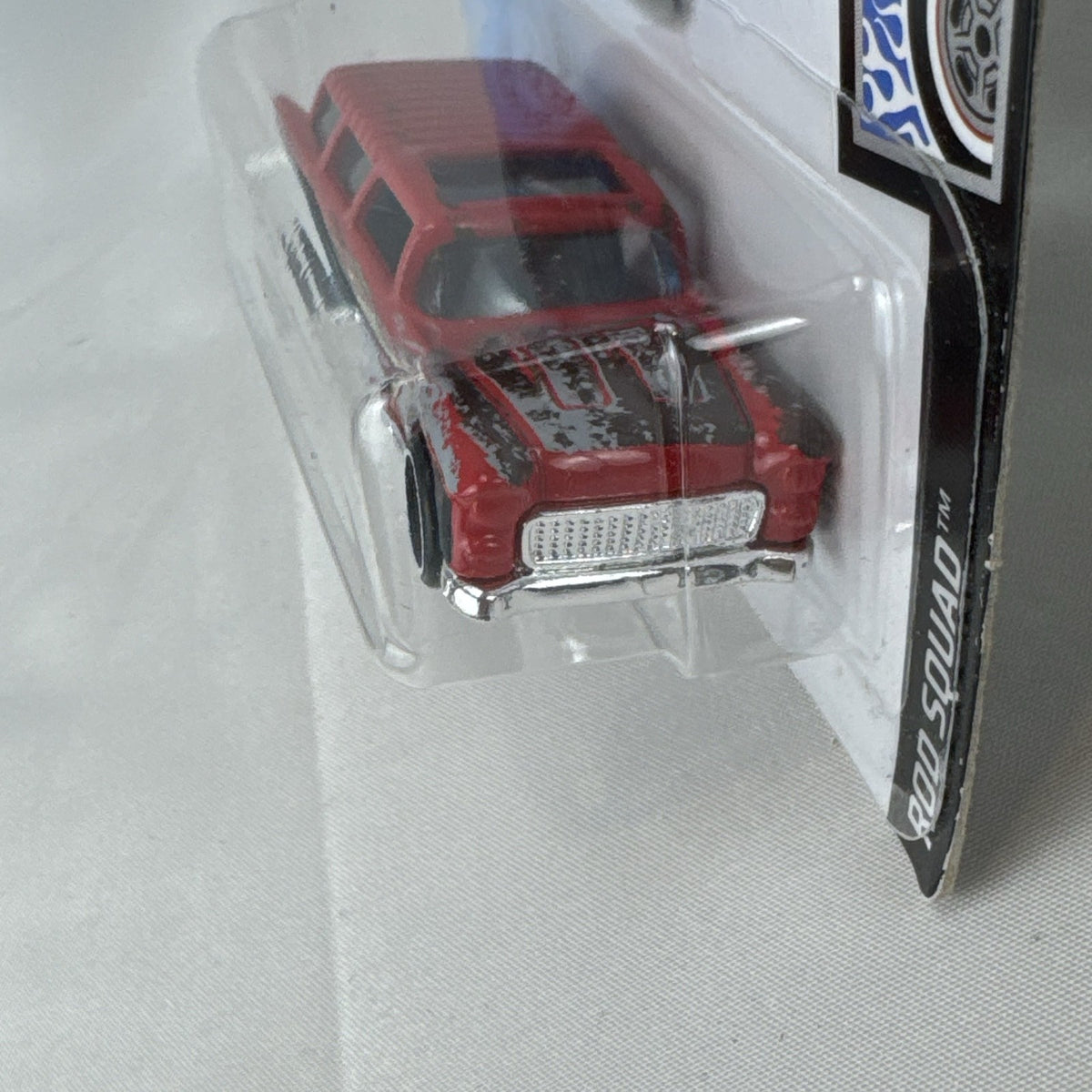 Sealed Hot Wheels 1955 Chevy Nomad diecast car in weathered red from the Rod Squad series