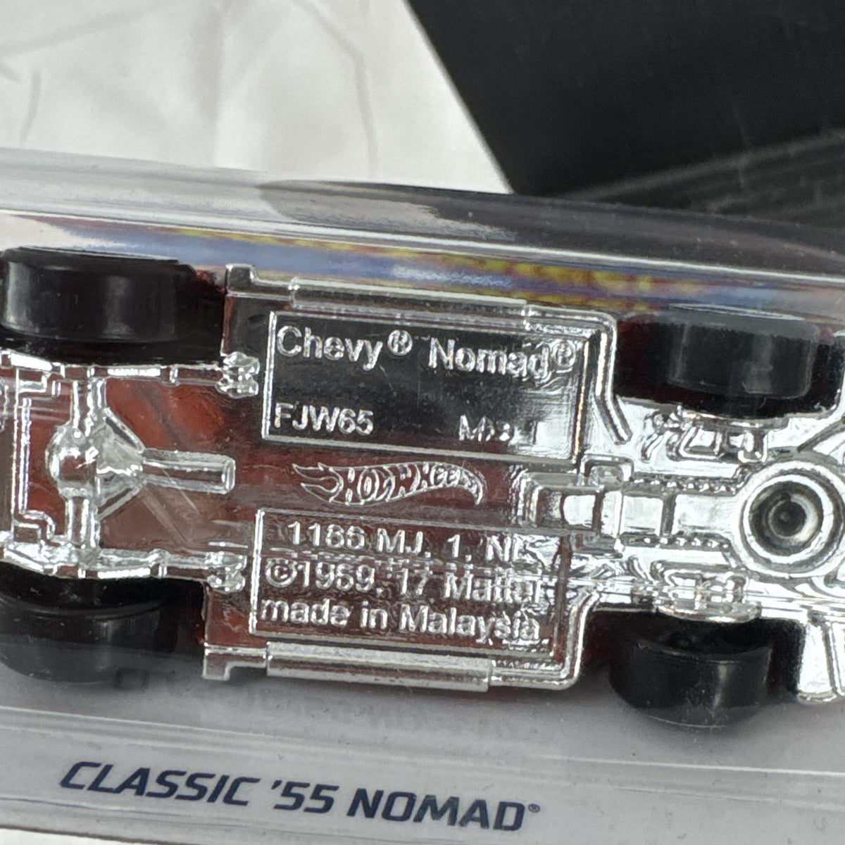 Sealed Hot Wheels 1955 Chevy Nomad diecast car in weathered red from the Rod Squad series