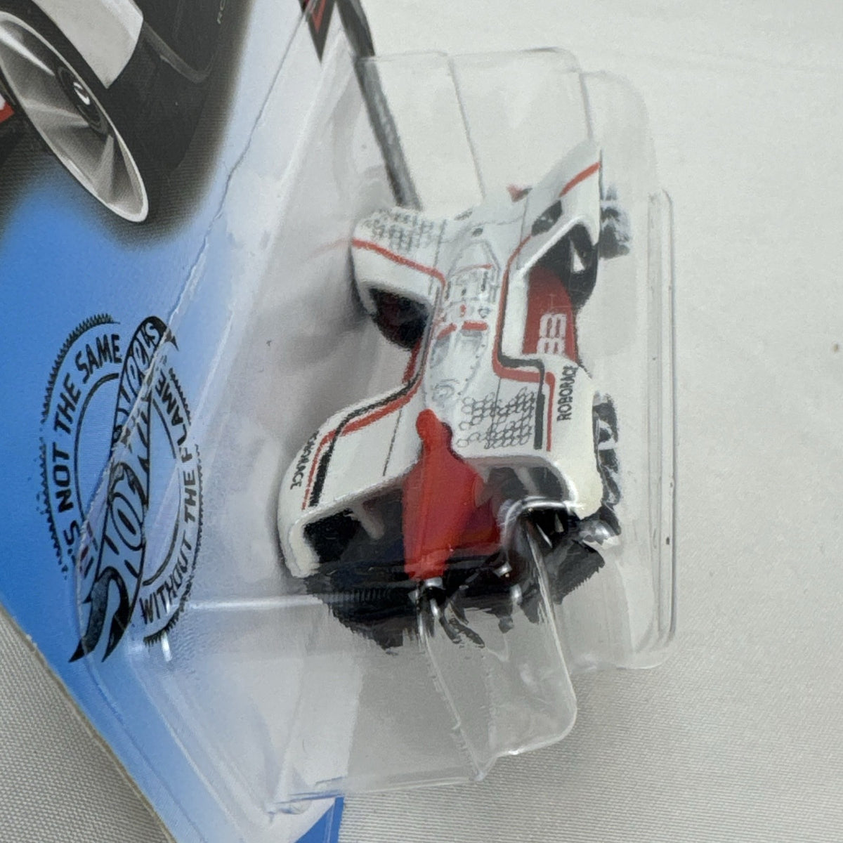 Hot Wheels 1:64 scale diecast Roborace Robocar in white with red accents in original blister pack.