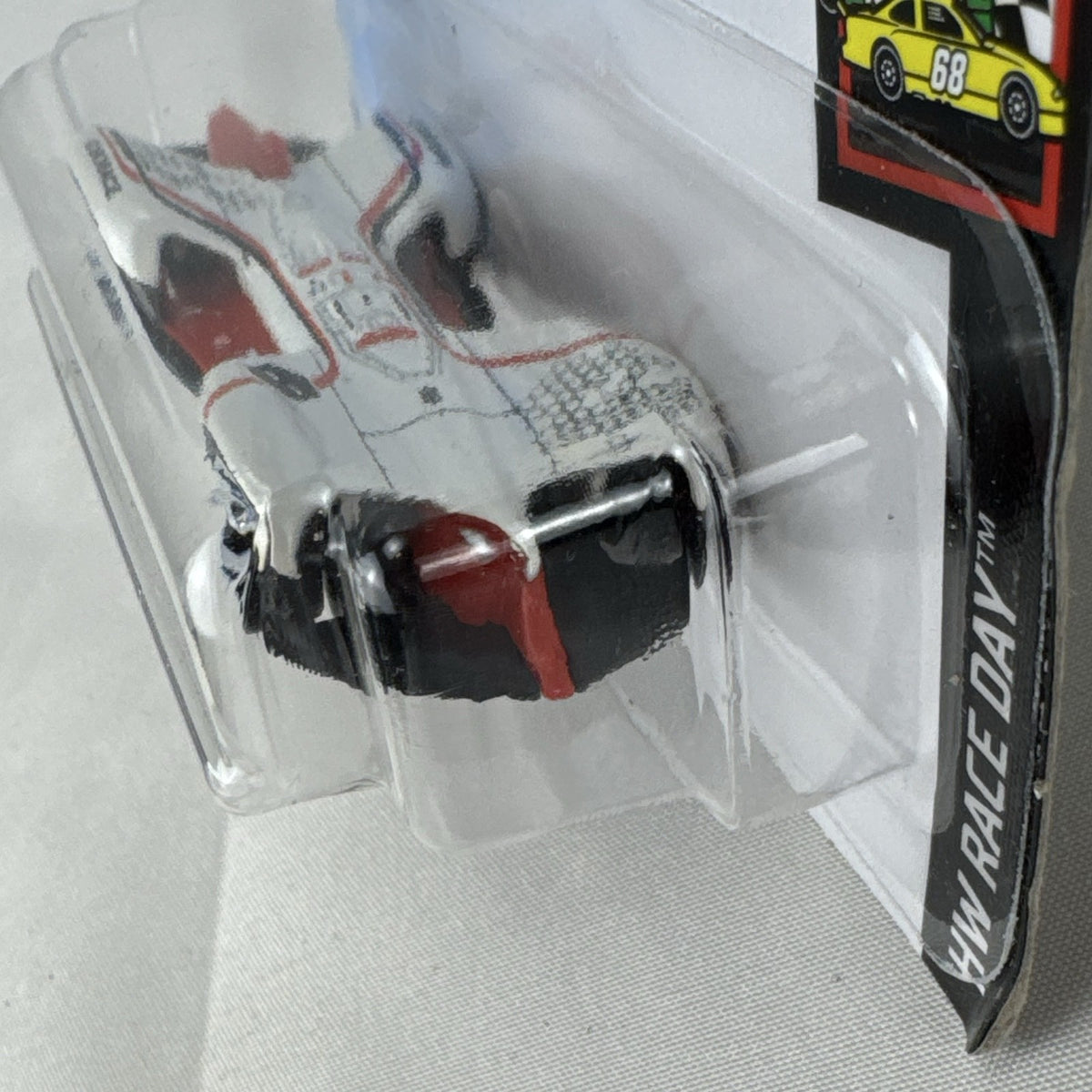 Hot Wheels 1:64 scale diecast Roborace Robocar in white with red accents in original blister pack.