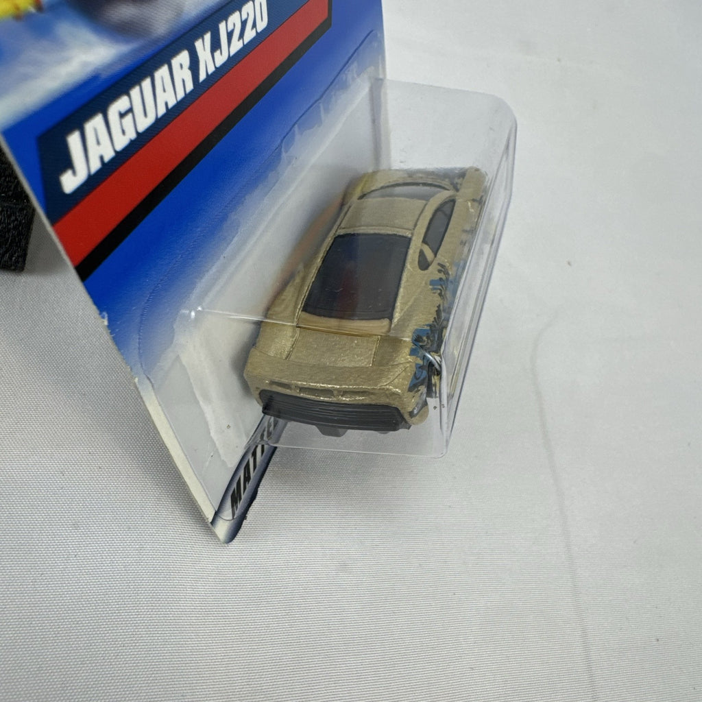 Hot Wheels 1:64 scale Jaguar XJ220 diecast car in metallic gold with 3-spoke wheels on unopened original card.