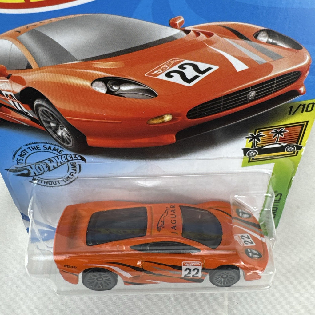 Hot Wheels HW Exotics 1:64 scale Jaguar XJ220 diecast car in bright orange racing livery sealed on original card
