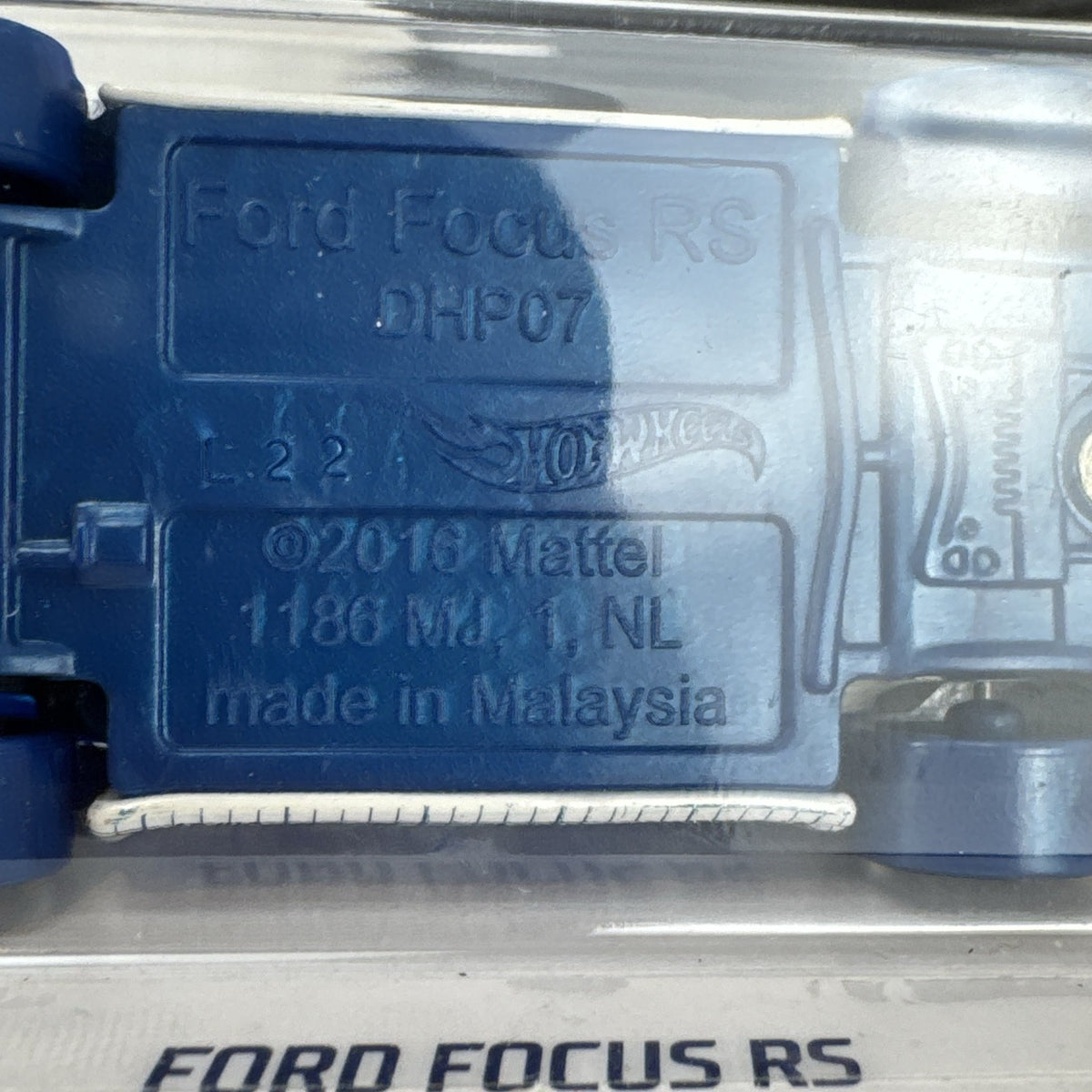 Hot Wheels 1:64 Ford Focus RS diecast car in white with blue blueprint graphics from the HW Art Cars series