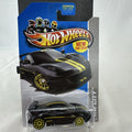 Hot Wheels 1:64 scale Lotus Evora GT4 diecast car in black with yellow stripes, factory sealed on original card